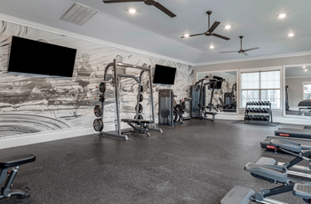 A spacious home gym with a variety of exercise equipment at Reserve by the Lake, Houston, TX